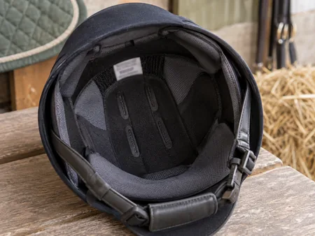 Close view inside a modern equestrian helmet showing padded lining.