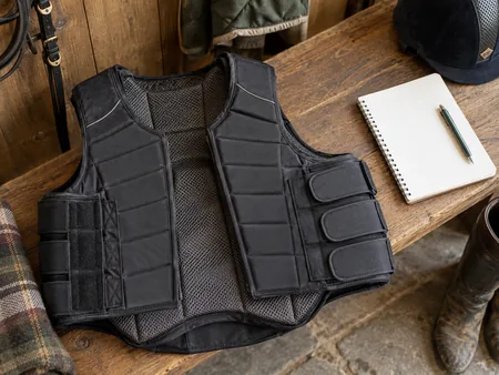 A second-hand equestrian body protector lying flat with inner lining and side fastening visible.
